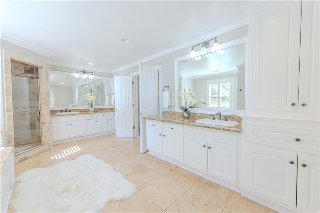 7680 Jett Ferry Road Atlanta, GA 30350 - Photo 31 of 74 a spacious bathroom with a granite countertop sink mirror and a bathtub