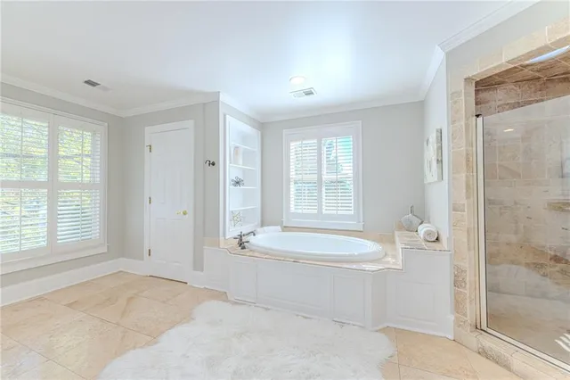 a spacious bathroom with a bathtub shower sink vanity and mirror