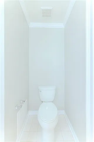 a view of a white house with many windows and plants