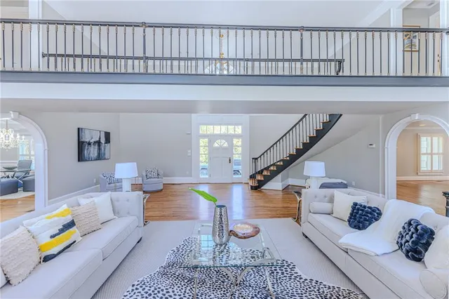 a large kitchen with kitchen island a large window a sink and stainless steel appliances