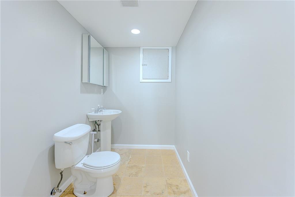 7680 Jett Ferry Road Atlanta, GA 30350 - Photo 63 of 74 a bathroom with a sink and a toilet