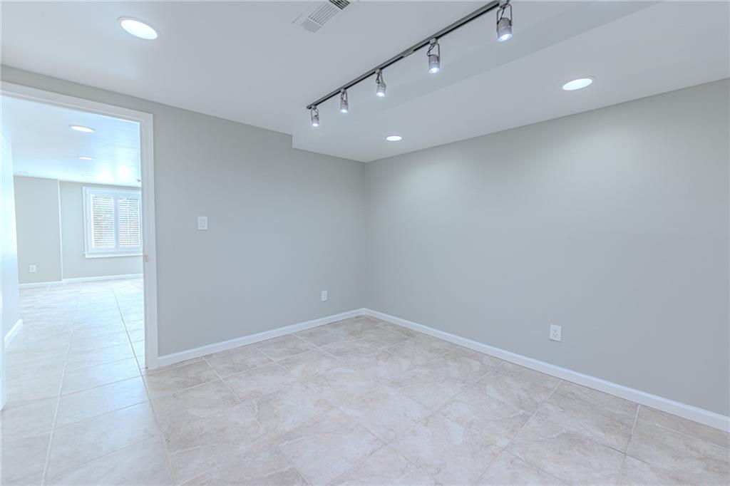 7680 Jett Ferry Road Atlanta, GA 30350 - Photo 64 of 74 an empty room with a empty space and windows