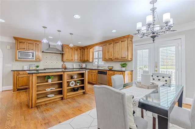 a kitchen with stainless steel appliances granite countertop a sink and cabinets
