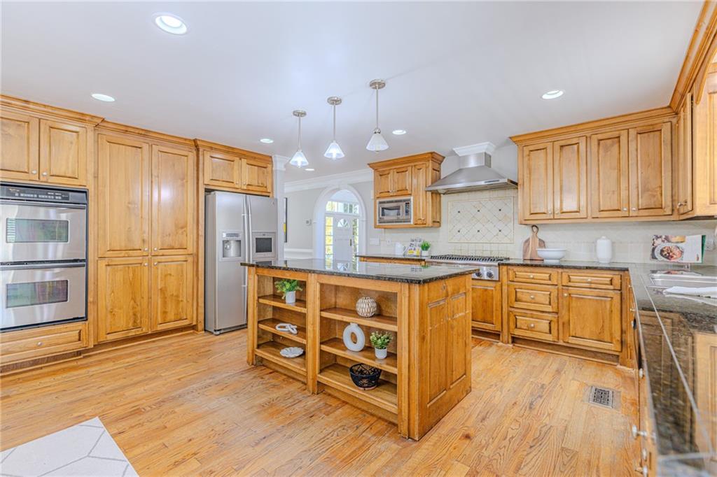 7680 Jett Ferry Road Atlanta, GA 30350 - Photo 10 of 74 a kitchen with stainless steel appliances granite countertop a refrigerator a stove top oven and a sink