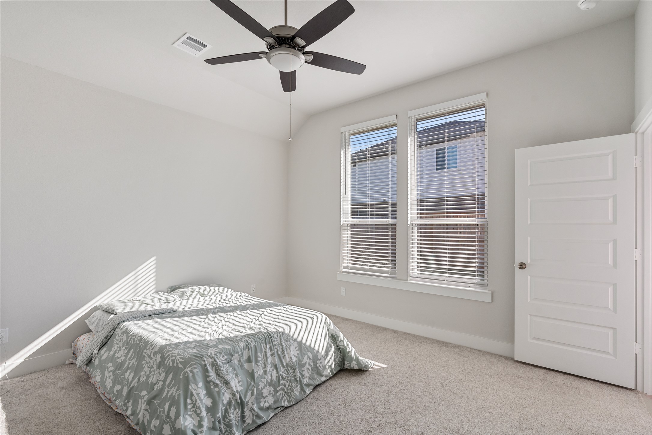 17623 Azalea Clf Court Richmond, TX 77407 - Photo 18 of 33 a bed sitting in a bedroom next to a window and a chandelier
