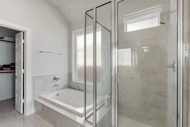 a bathroom with a bathtub and a shower