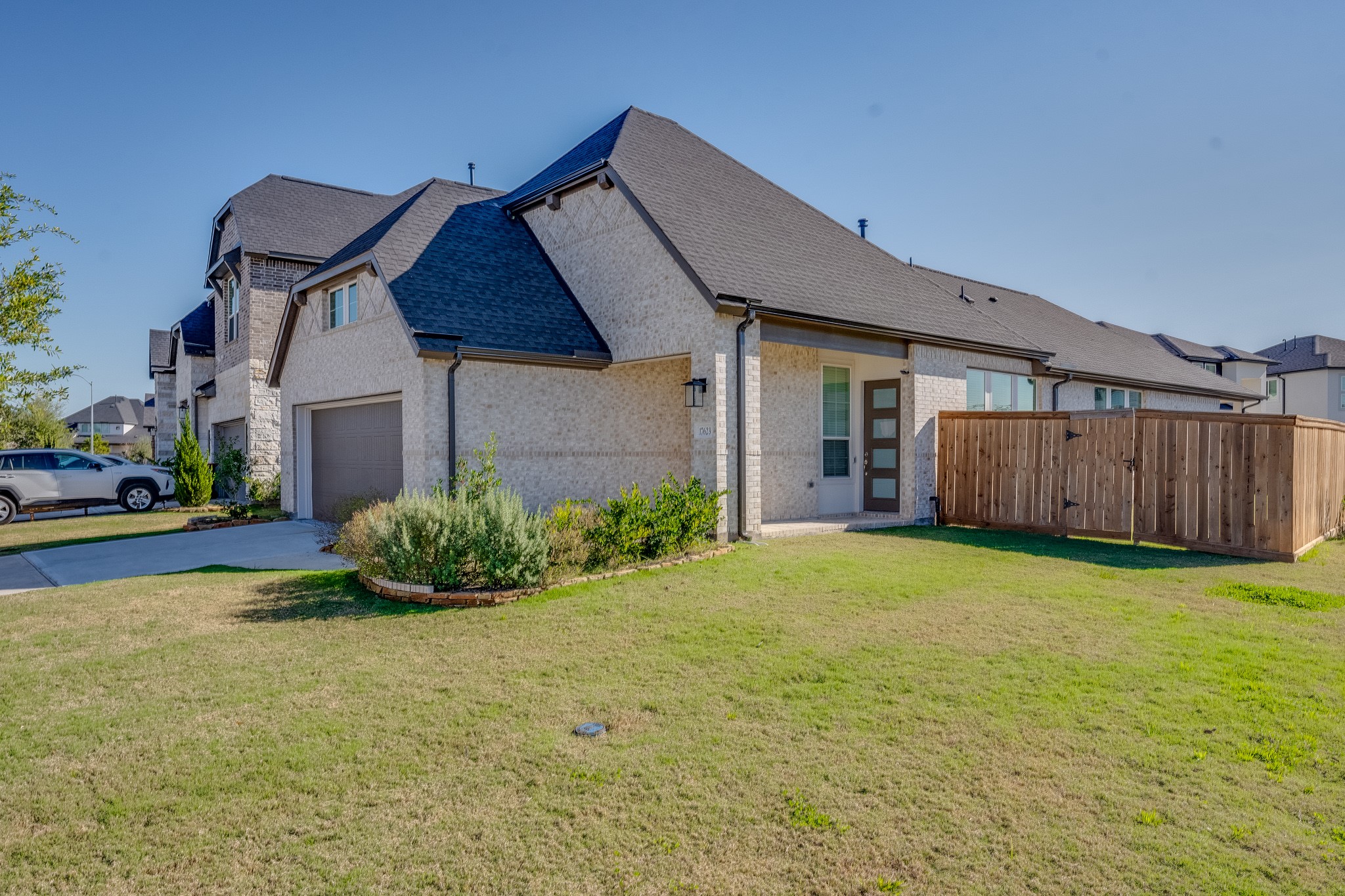 17623 Azalea Clf Court Richmond, TX 77407 - Photo 7 of 33 a house view with a garden space