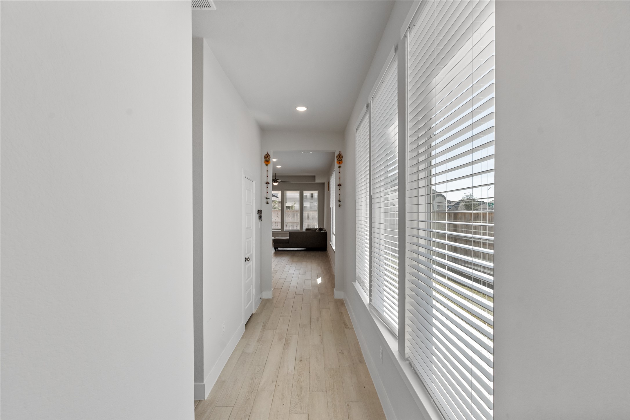 17623 Azalea Clf Court Richmond, TX 77407 - Photo 8 of 33 a view of a hallway with wooden floor and a bathroom