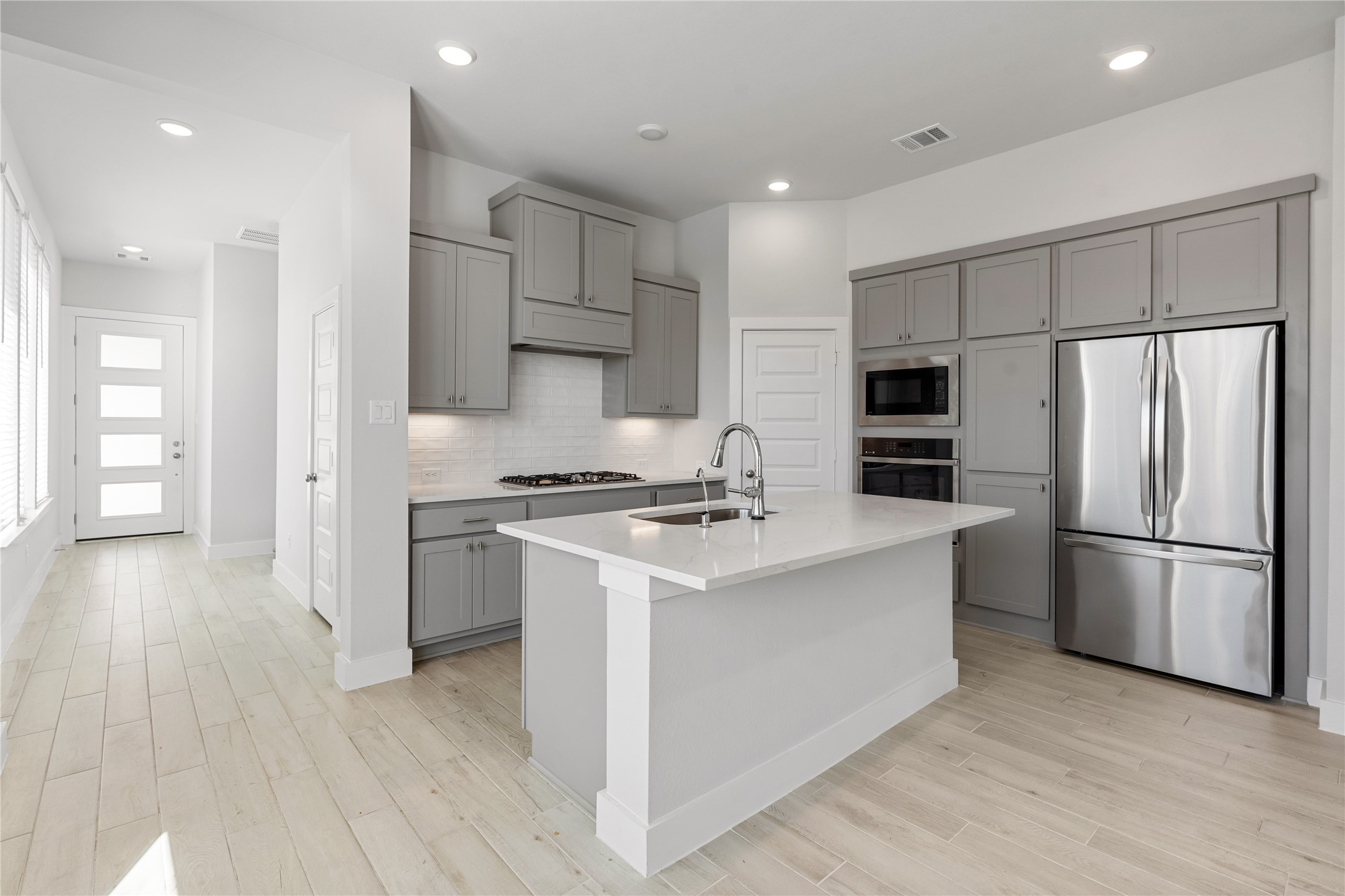 17623 Azalea Clf Court Richmond, TX 77407 - Photo 10 of 33 a kitchen with stainless steel appliances a refrigerator sink and cabinets