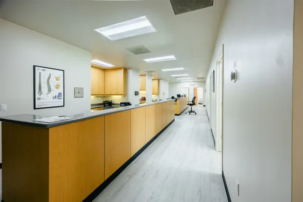 a large white kitchen with a large window