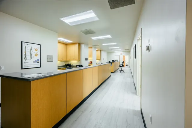 a large white kitchen with a large window