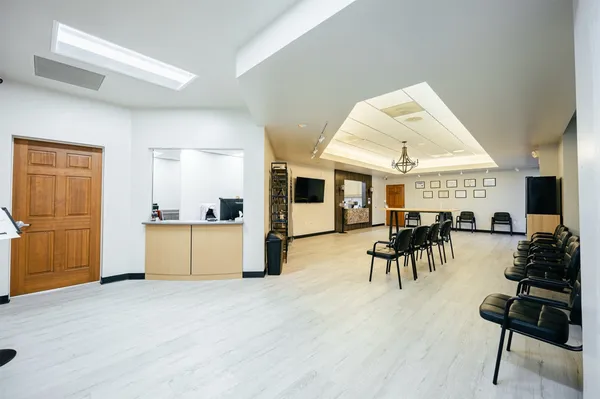 a view of a dining room with furniture and a kitchen view
