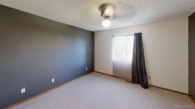 an empty room with a empty space and windows