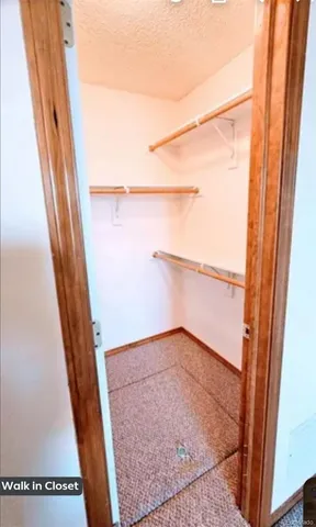 an empty room with closet and mirror