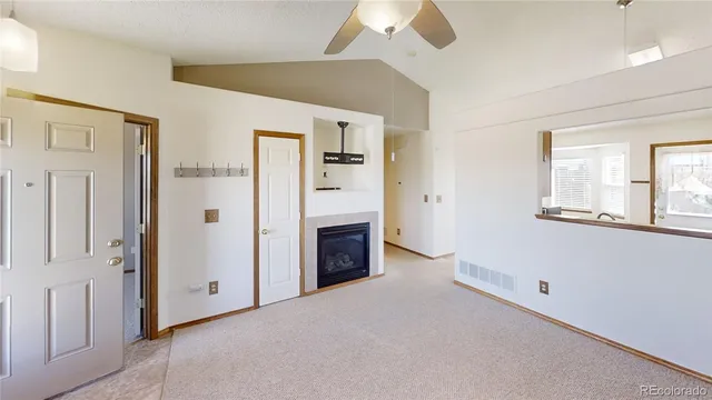 a view of a livingroom with an empty space and a fireplace