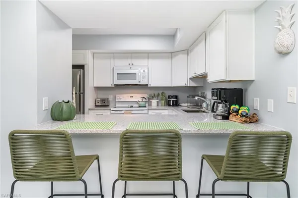 a kitchen with a cabinets and chairs