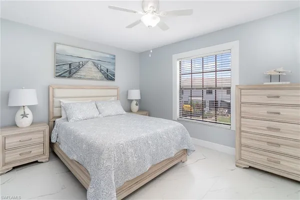 a bedroom with a bed a dresser and a window