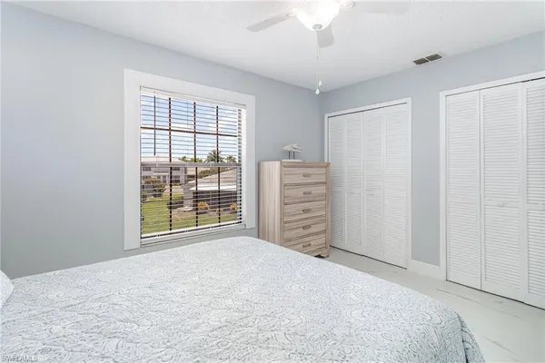 a view of a bedroom with cabinet and a large window