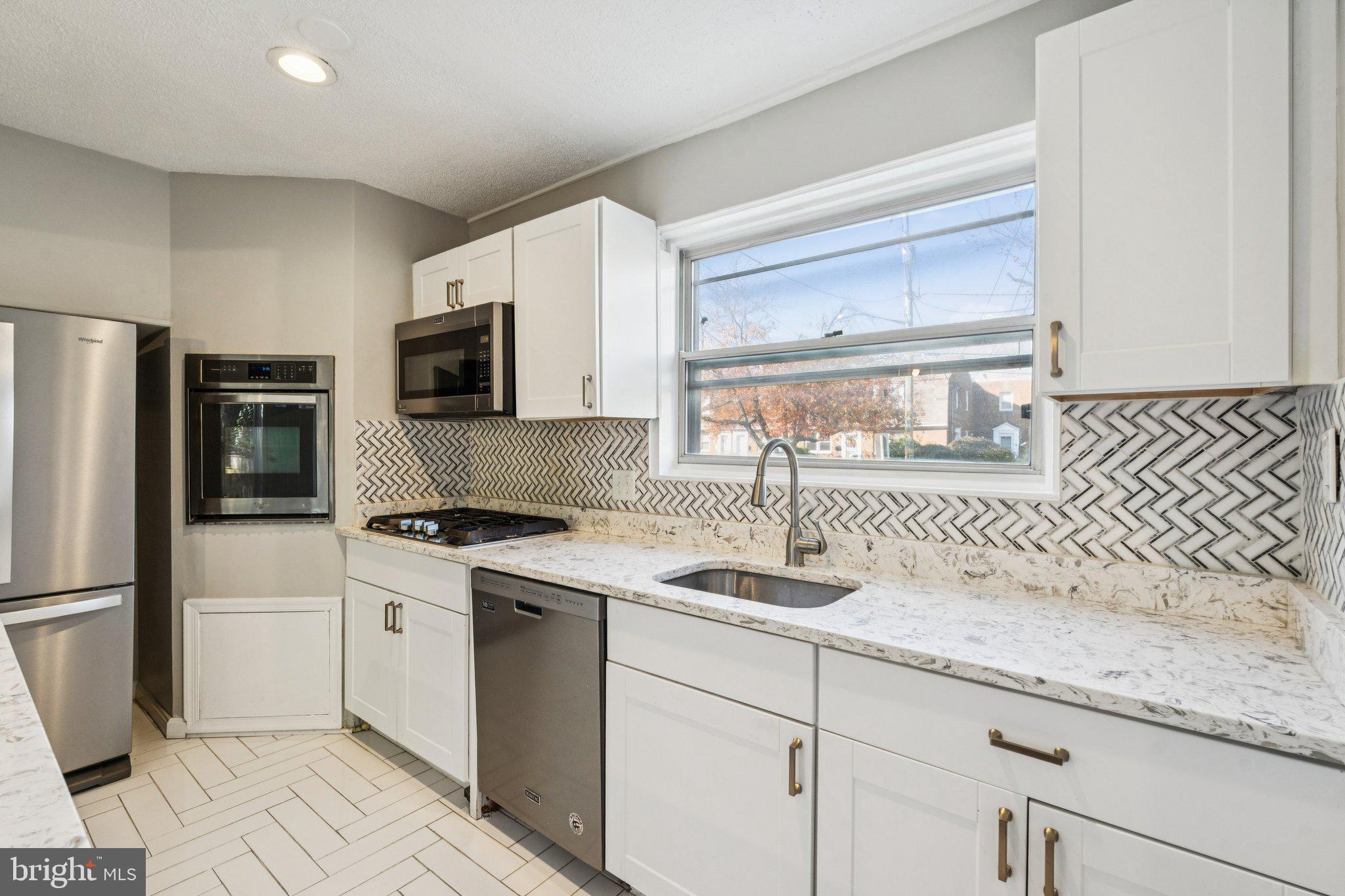 2803 Keating Street Temple Hills, MD 20748 - Photo 4 of 20 a kitchen with a sink stove and refrigerator