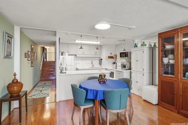 a view of a dining room with furniture and wooden floor