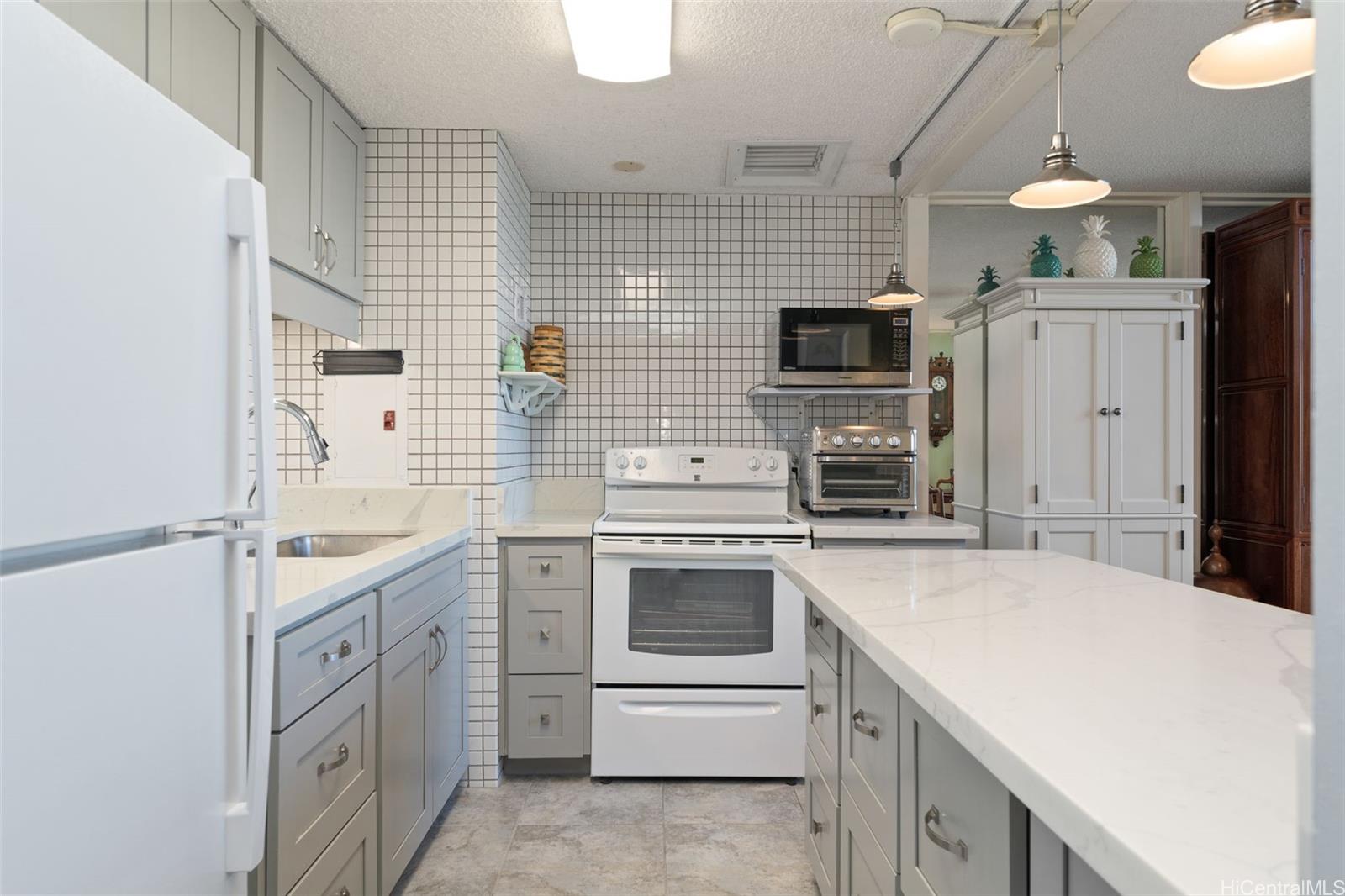 666 Prospect Street, Unit I402 Honolulu, HI 96813 - Photo 6 of 19 a kitchen with a sink stove and refrigerator