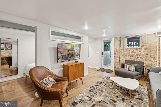 a view of a hallway with workspace and a window