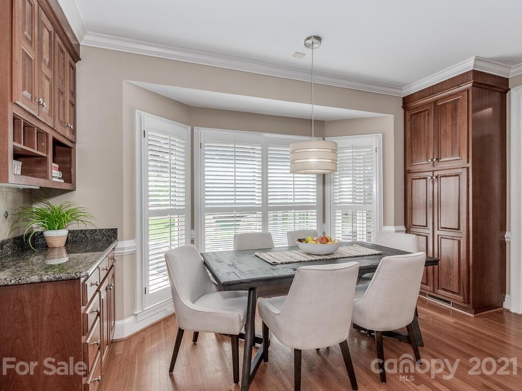 4743 Binfords Ridge Road Charlotte, NC 28226 - Photo 12 of 41 a dining room with furniture and wooden floor