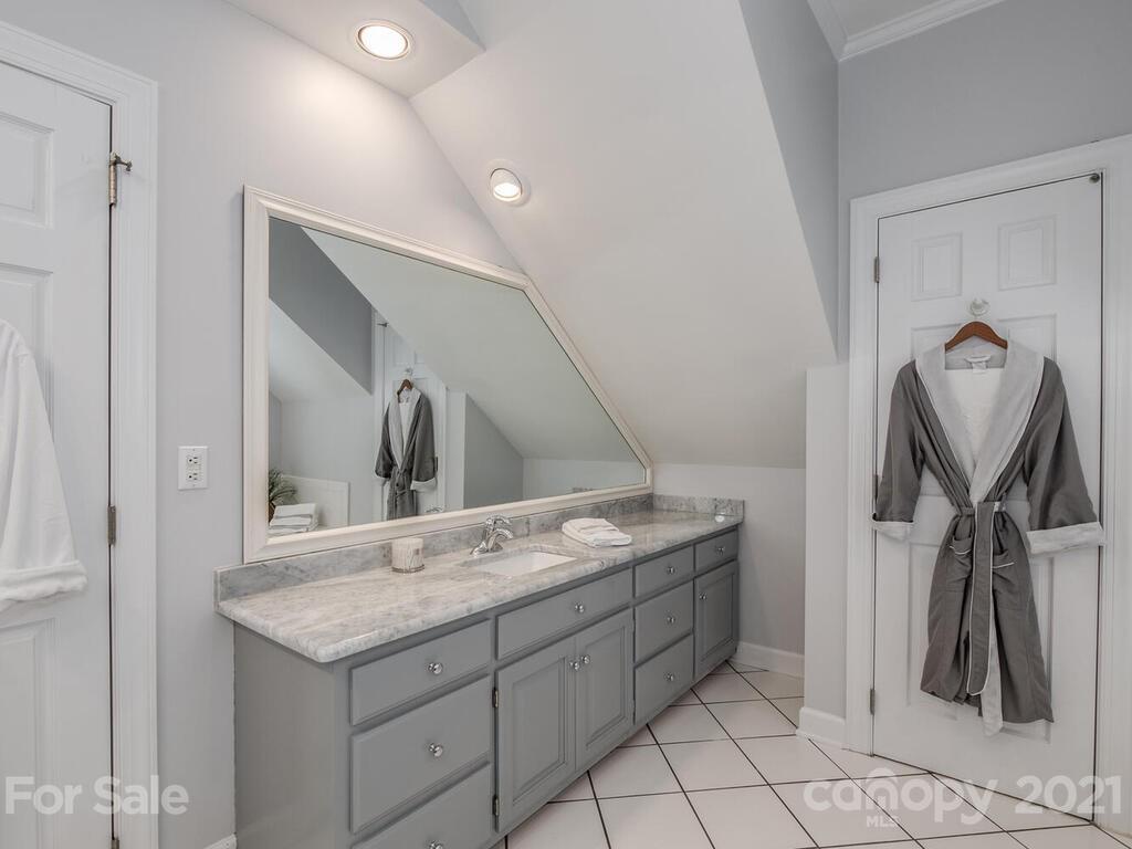 4743 Binfords Ridge Road Charlotte, NC 28226 - Photo 19 of 41 a bathroom with a granite countertop sink and a mirror