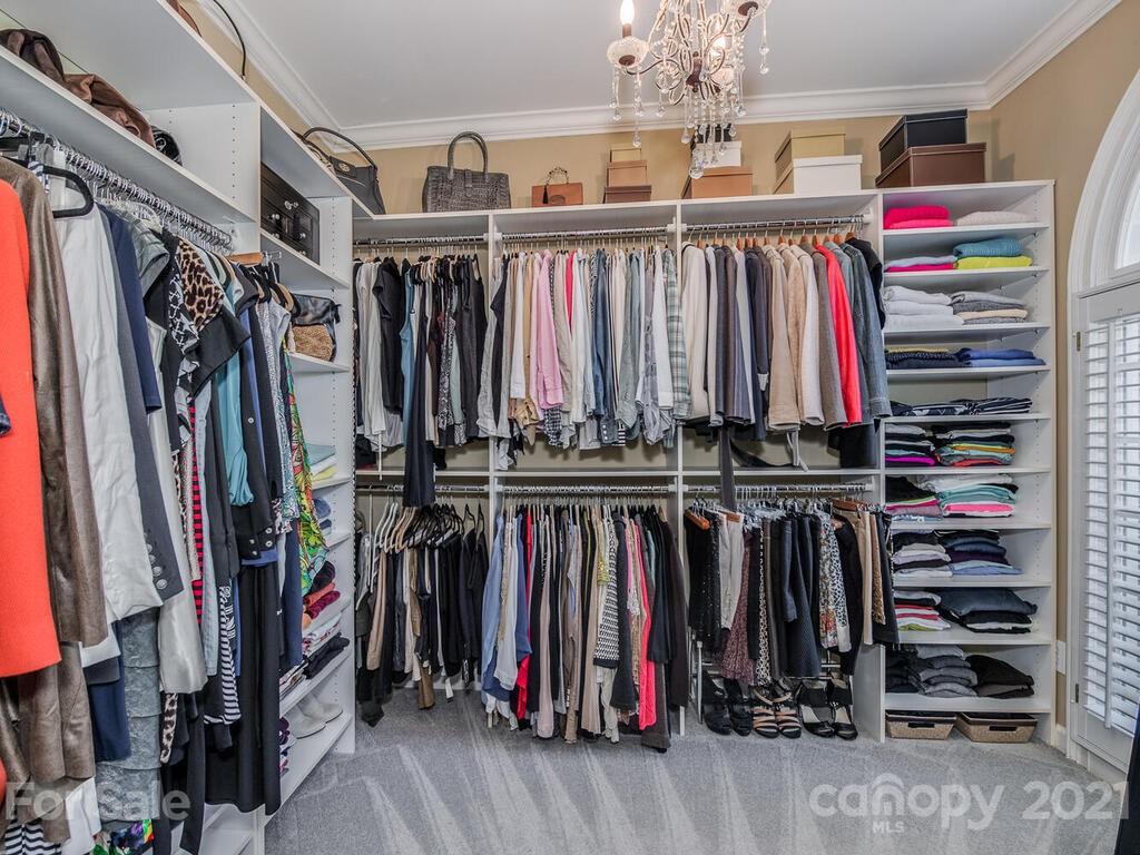 4743 Binfords Ridge Road Charlotte, NC 28226 - Photo 21 of 41 a view of walk in closet with clothes