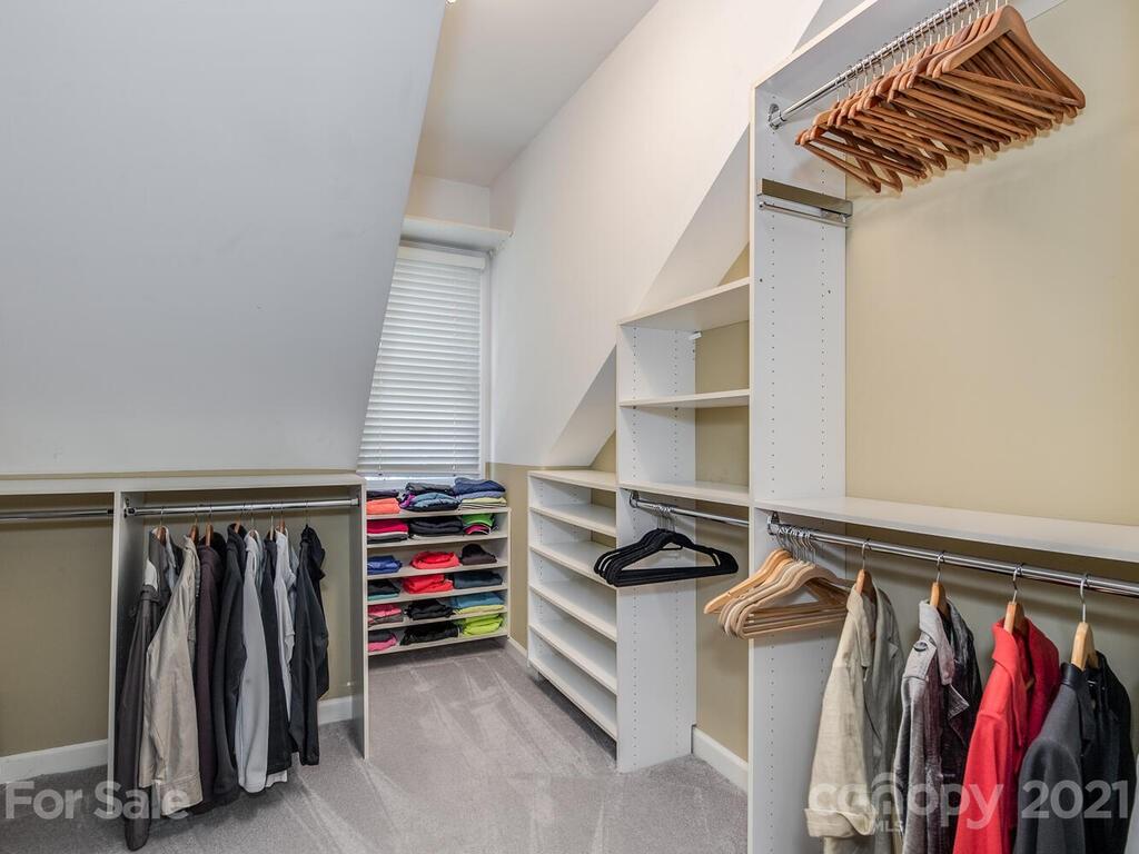 4743 Binfords Ridge Road Charlotte, NC 28226 - Photo 22 of 41 a view of walk in closet with clothes and shoes