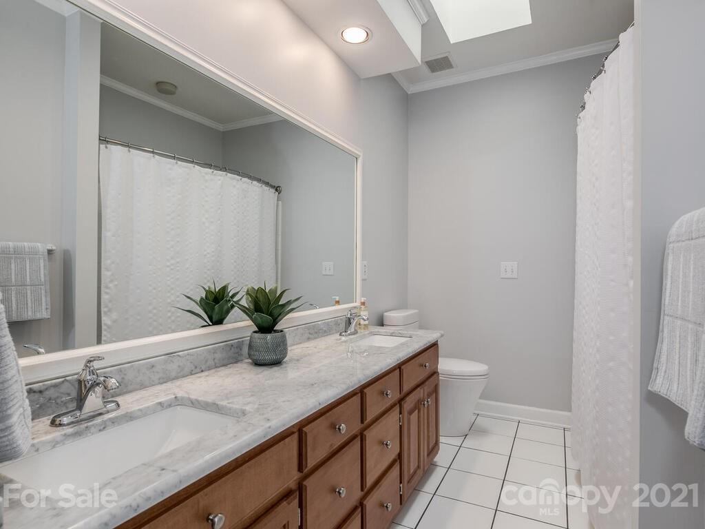 4743 Binfords Ridge Road Charlotte, NC 28226 - Photo 24 of 41 a bathroom with a double vanity sink and a mirror