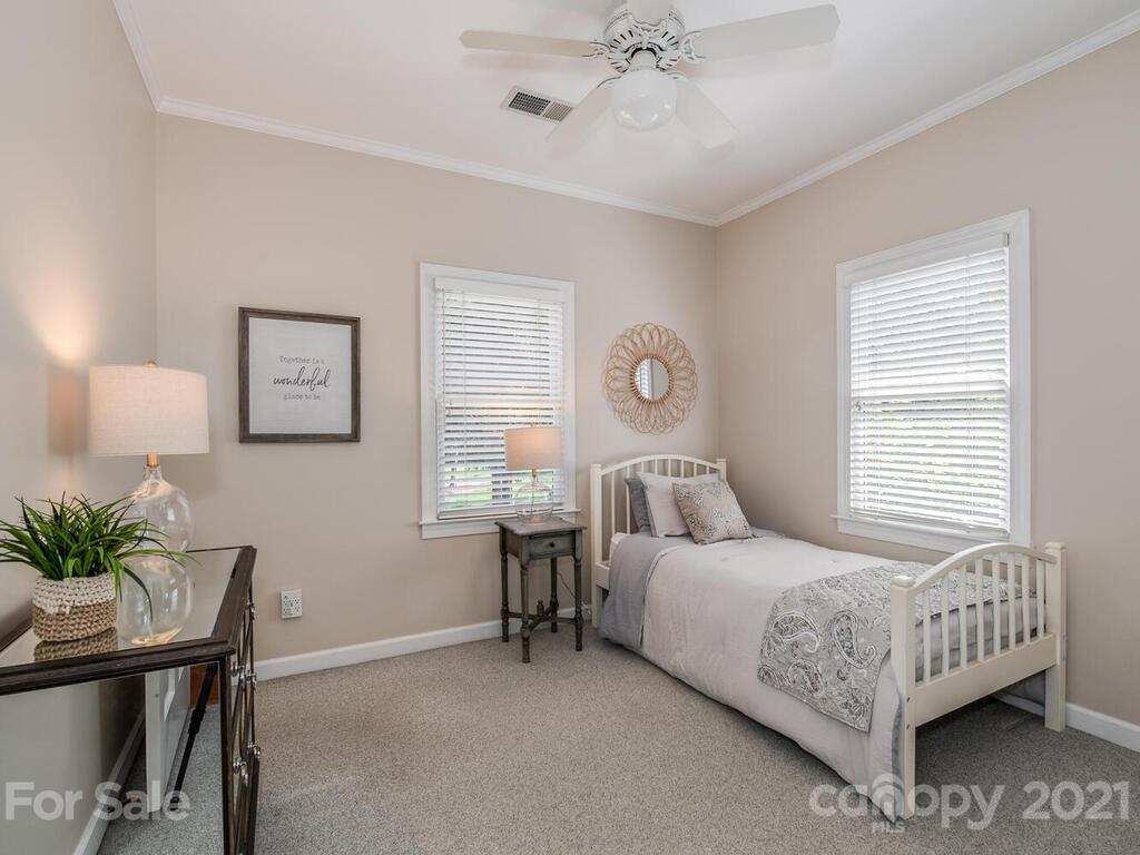 4743 Binfords Ridge Road Charlotte, NC 28226 - Photo 27 of 41 a bedroom with a bed a table and chair