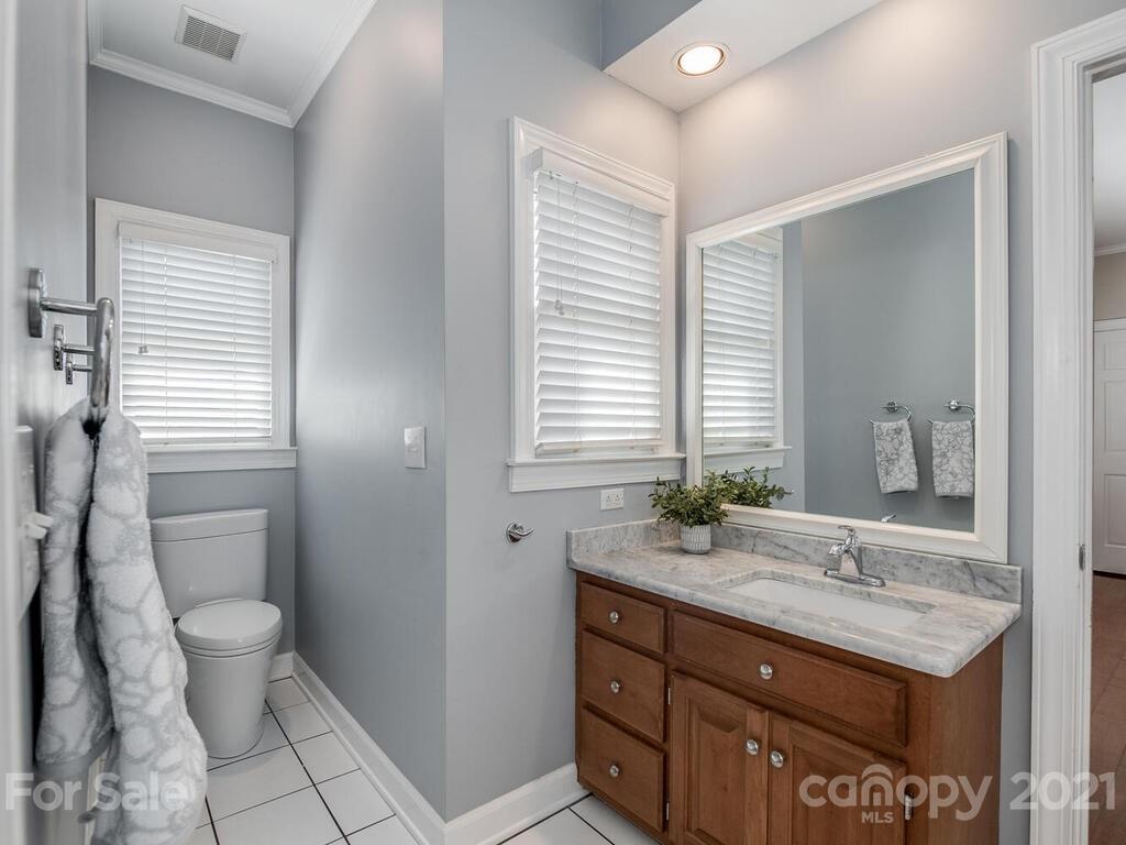 4743 Binfords Ridge Road Charlotte, NC 28226 - Photo 28 of 41 a bathroom with a granite countertop sink toilet and mirror