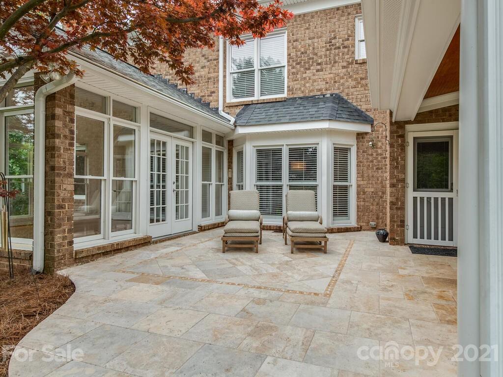 4743 Binfords Ridge Road Charlotte, NC 28226 - Photo 33 of 41 a backyard of a house with seating space and large windows