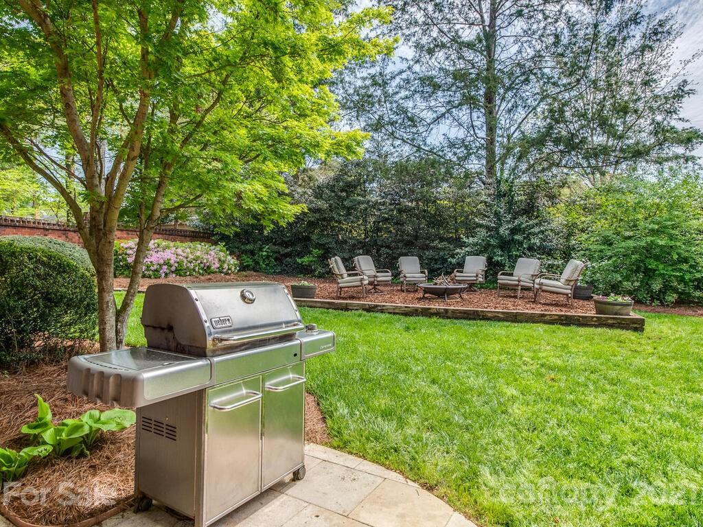 4743 Binfords Ridge Road Charlotte, NC 28226 - Photo 34 of 41 a backyard of a house with table and chairs