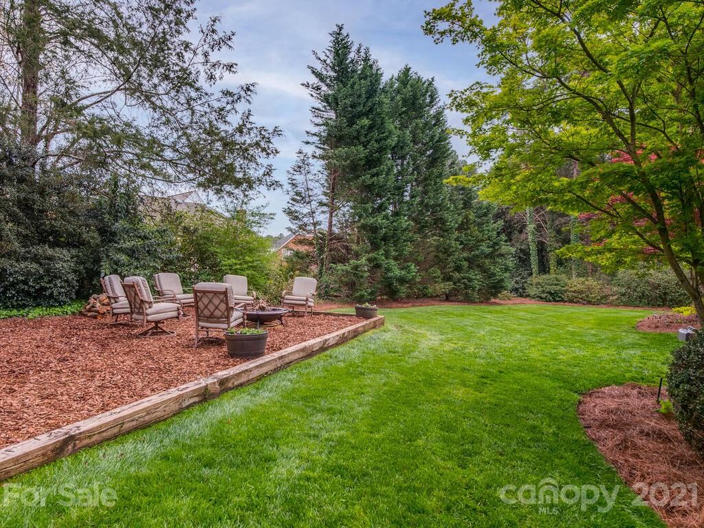 4743 Binfords Ridge Road Charlotte, NC 28226 - Photo 36 of 41 a view of a backyard with chairs and a table
