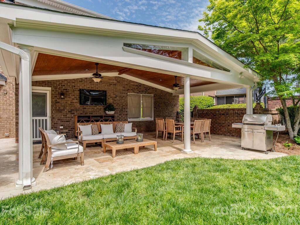 4743 Binfords Ridge Road Charlotte, NC 28226 - Photo 39 of 41 a view of a patio with table and chairs potted plants and a large tree