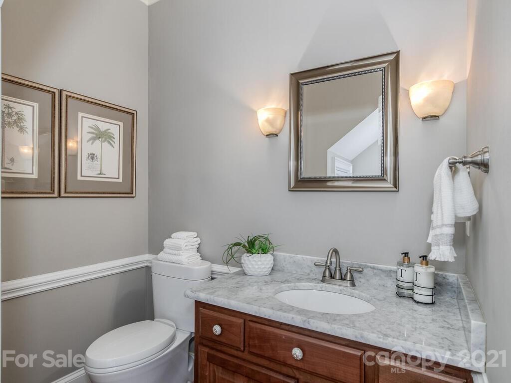 4743 Binfords Ridge Road Charlotte, NC 28226 - Photo 7 of 41 a bathroom with a granite countertop toilet sink and mirror
