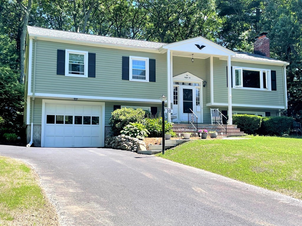 a front view of a house with a yard and porch