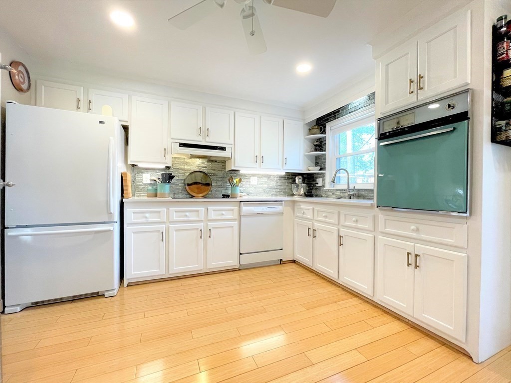 10 Phyllis Road Foxboro, MA 02035 - Photo 8 of 28 a kitchen with white cabinets and white appliances