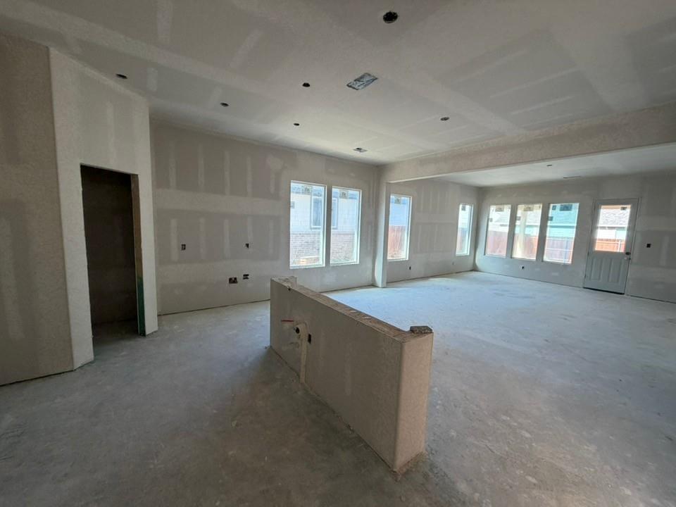 1237 Colca Drive Springtown, TX 76082 - Photo 4 of 9 wooden floor in an empty room with a kitchen