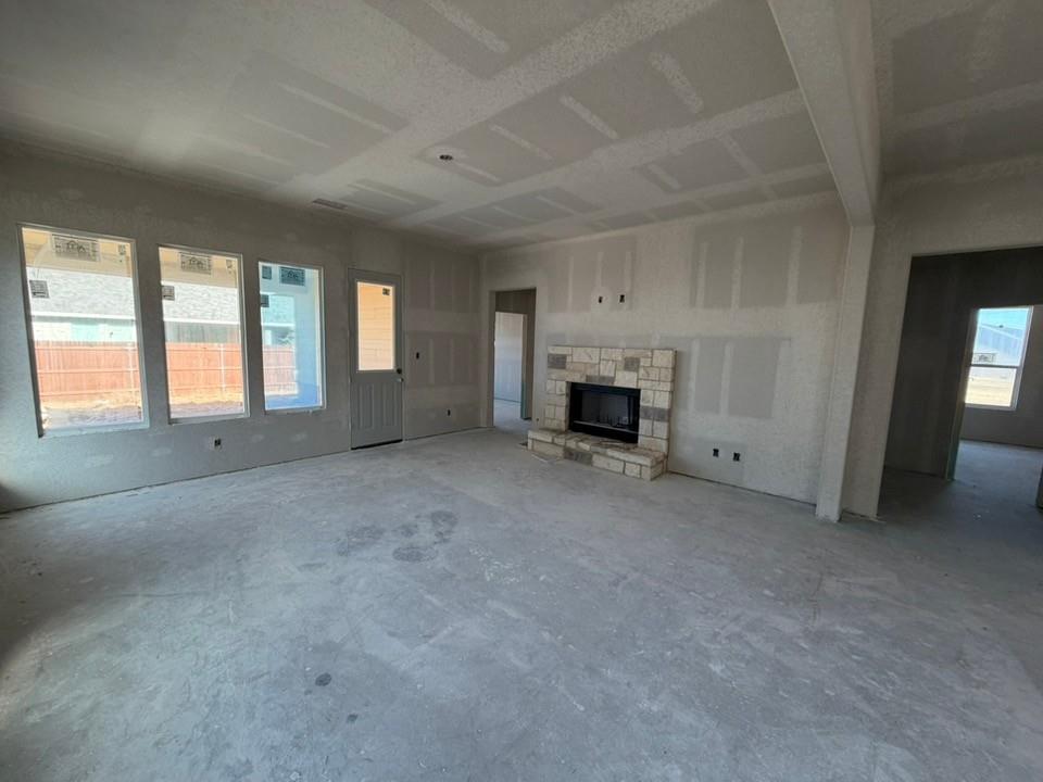1237 Colca Drive Springtown, TX 76082 - Photo 5 of 9 an empty room with furniture and a fireplace