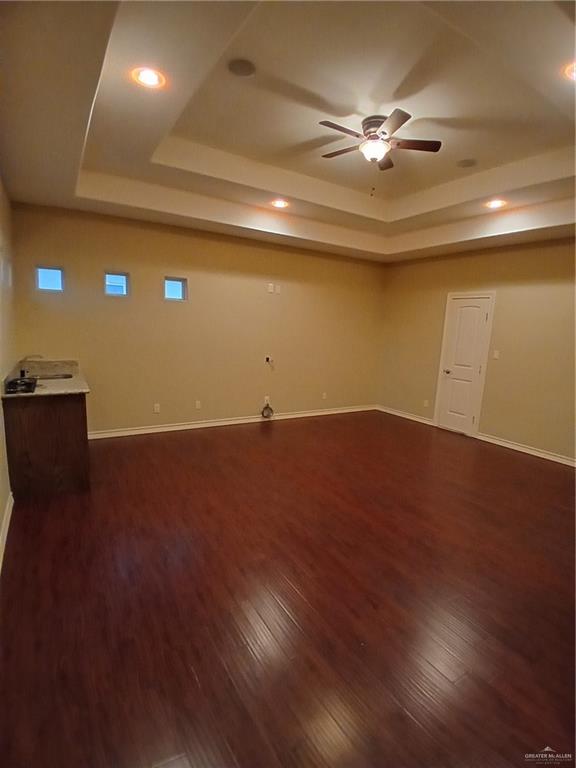 2423 West Hampton Avenue Edinburg, TX 78539 - Photo 11 of 15 a view of a room with wooden floor and a ceiling fan