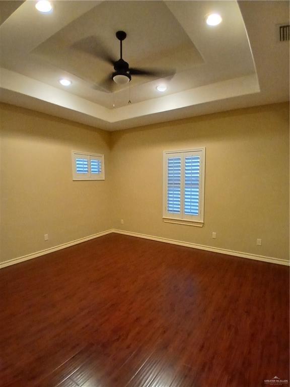 2423 West Hampton Avenue Edinburg, TX 78539 - Photo 12 of 15 a view of an empty room with wooden floor and a ceiling fan