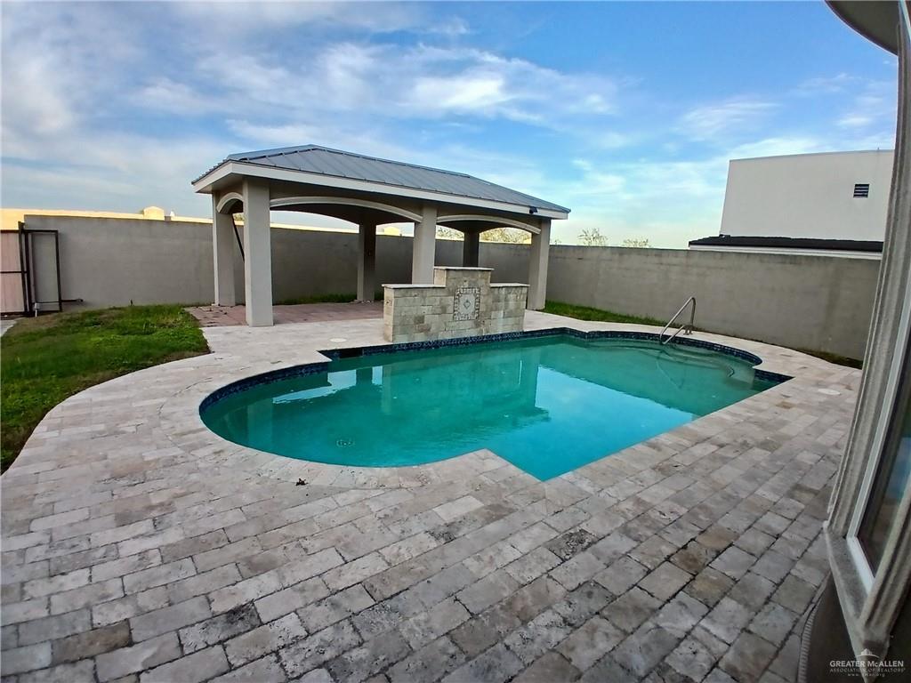 2423 West Hampton Avenue Edinburg, TX 78539 - Photo 13 of 15 a view of a house with a swimming pool and a yard