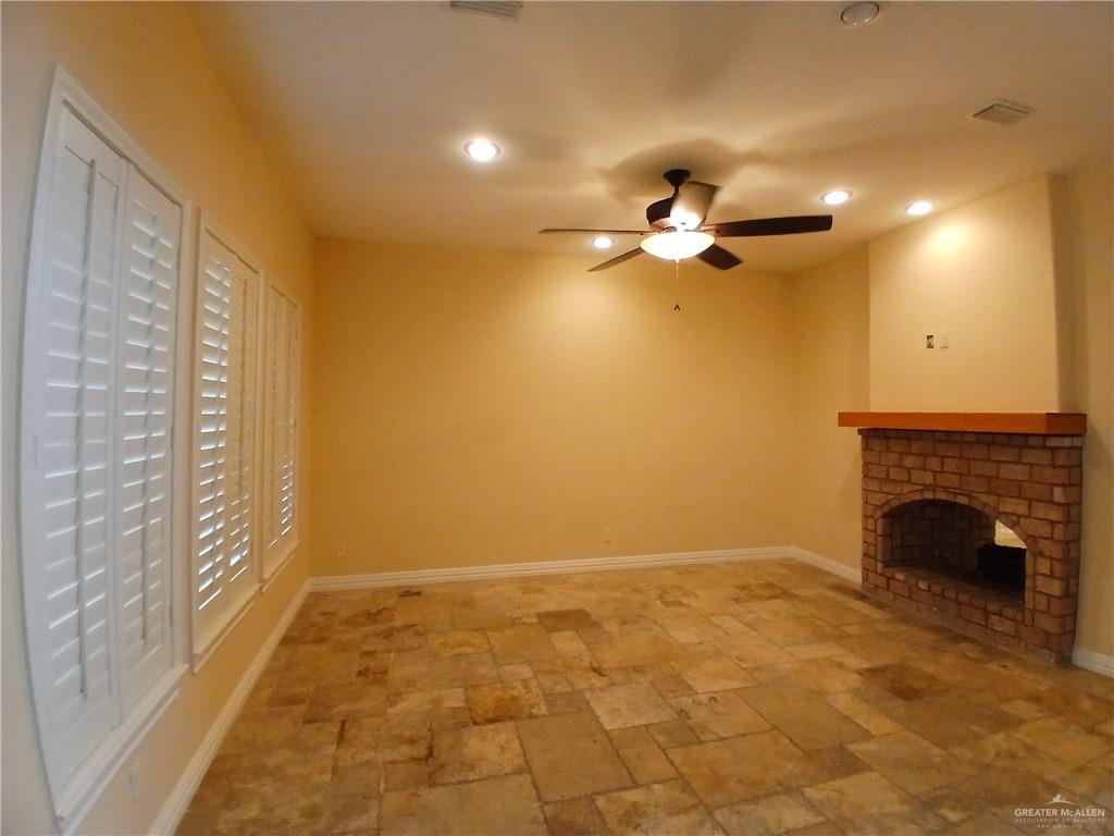 2423 West Hampton Avenue Edinburg, TX 78539 - Photo 4 of 15 a view of an empty room with a fireplace and a window