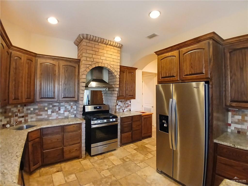 2423 West Hampton Avenue Edinburg, TX 78539 - Photo 5 of 15 a kitchen with stainless steel appliances granite countertop a refrigerator stove and sink