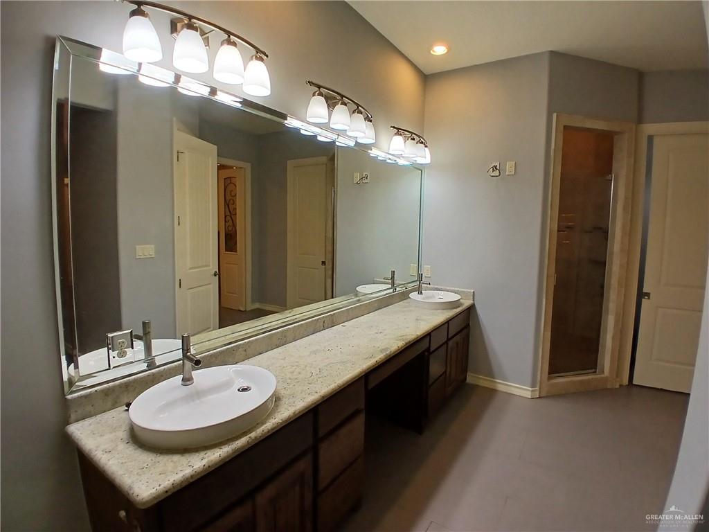 2423 West Hampton Avenue Edinburg, TX 78539 - Photo 8 of 15 a bathroom with a sink and a mirror