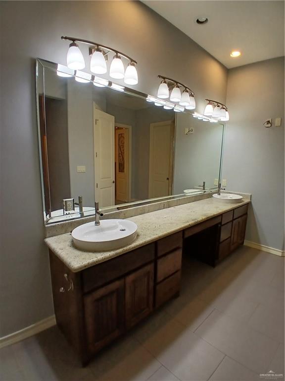 2423 West Hampton Avenue Edinburg, TX 78539 - Photo 10 of 15 a bathroom with a double vanity sink and a mirror