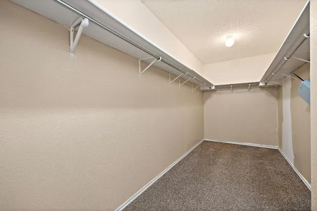 a spacious bathroom with a double vanity sink and a mirror